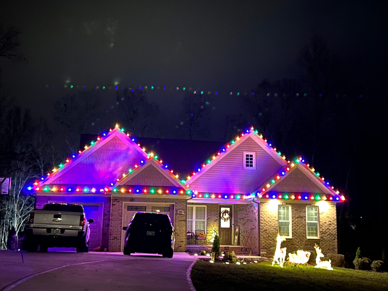 Professional color-changing Christmas light display on a home